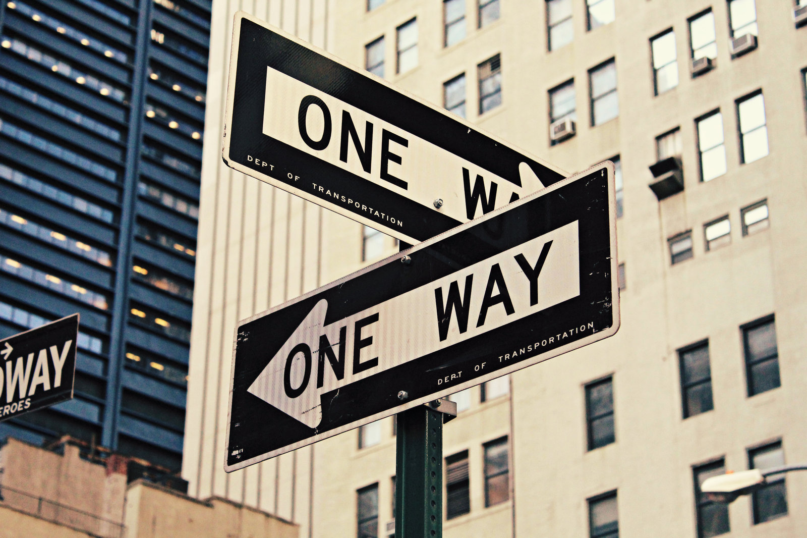 Multiple "one way" road signs pointing to different directions