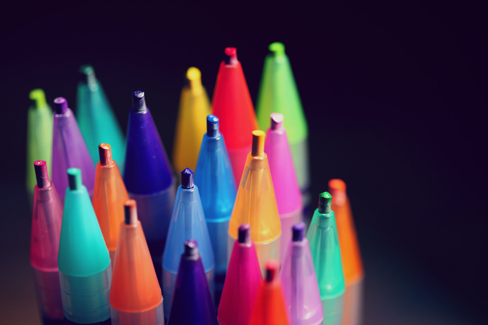 Multi-colored pencils on a black background