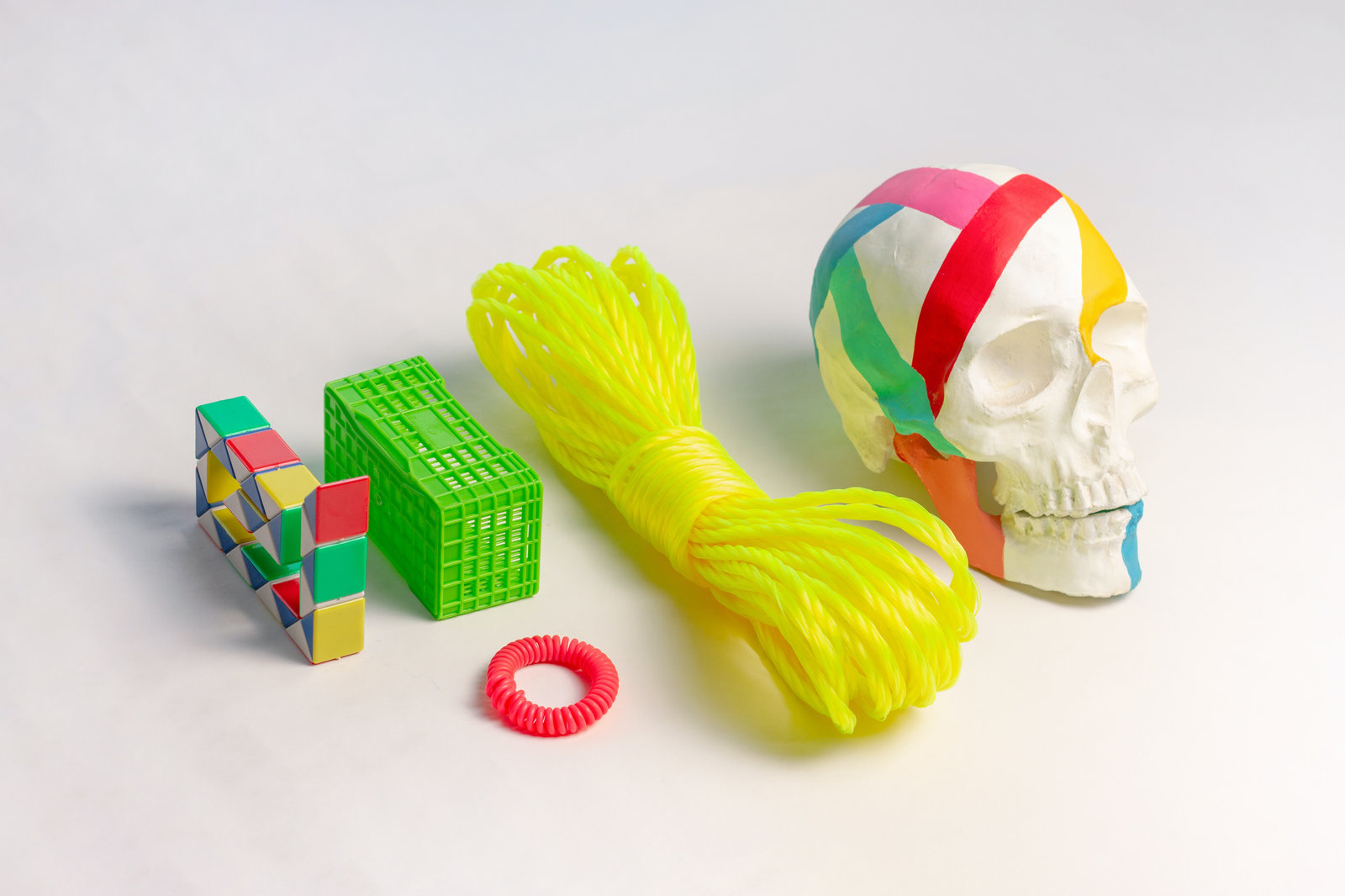 Flat lay of bizzare and colorful objects on white background