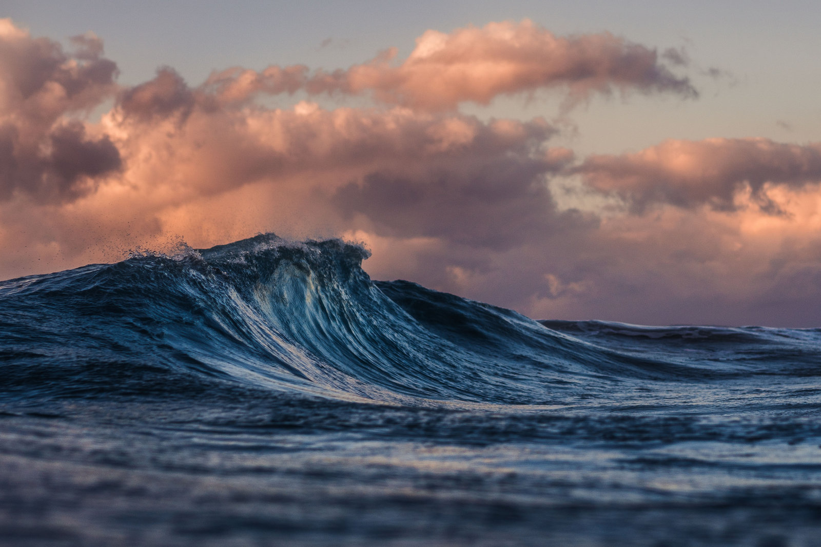 A crashing wave in the dusk